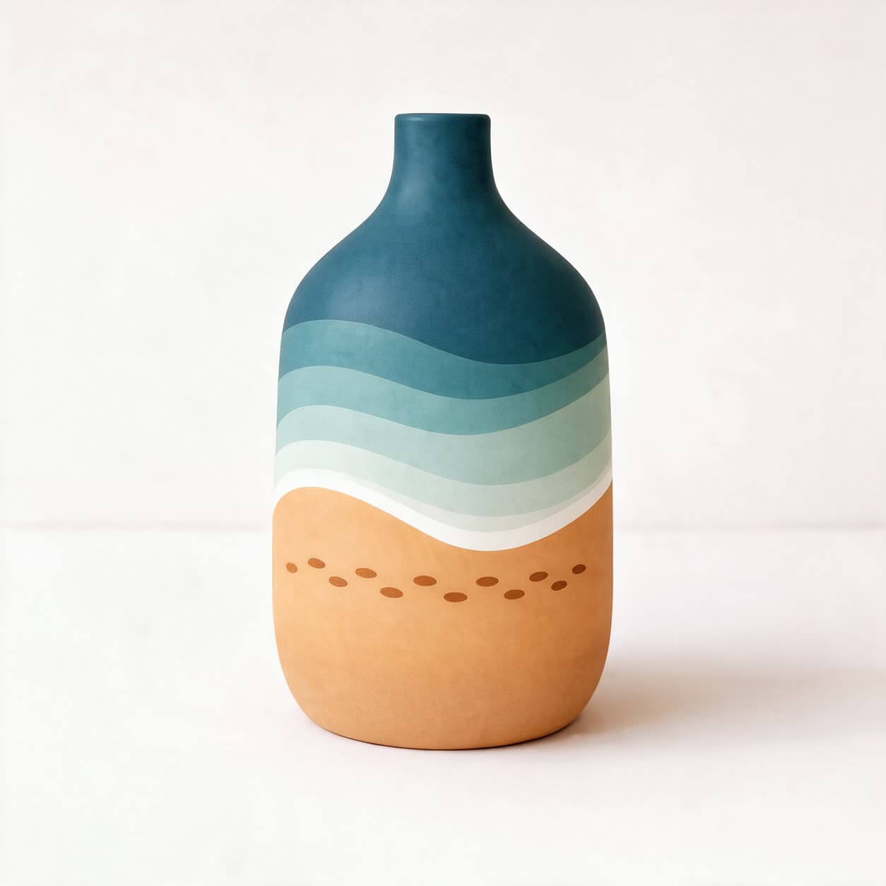 Matte ceramic bottle vase with deep blue and teal wave bands flowing over a sand-coloured lower half marked with a row of dots, on a warm off-white background